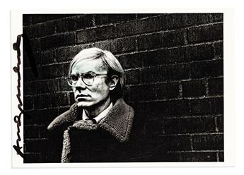 WARHOL, ANDY. Photograph postcard Signed, twice, bust portrait by Pepe Diniz, showing him standing against a brick wall and looking int